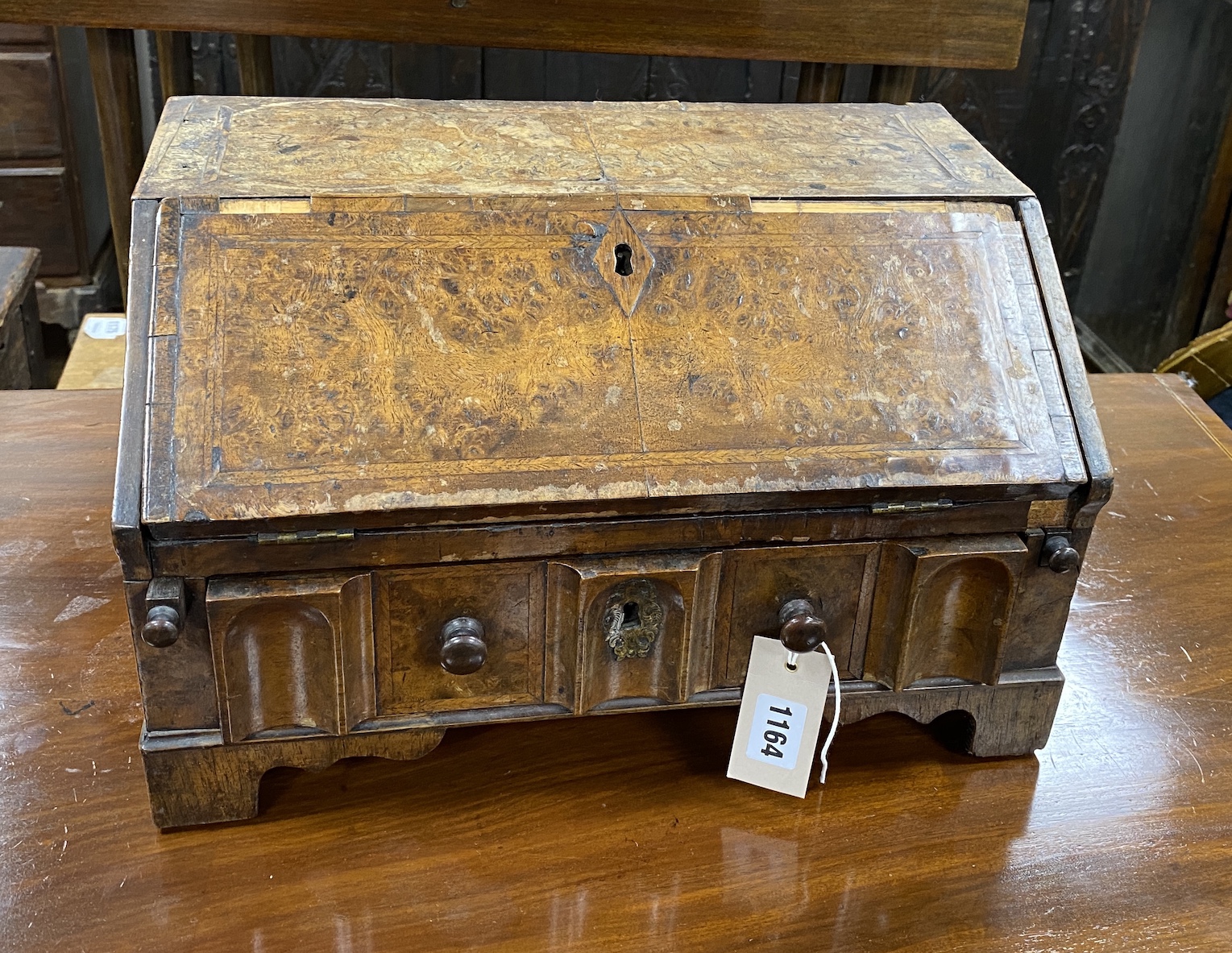 A small early 18th century feather banded walnut table-top bureau, width 40cm, depth 25cm, height 24cm, NB: From the Estate of Rt Hon Lord Lawson of Blaby